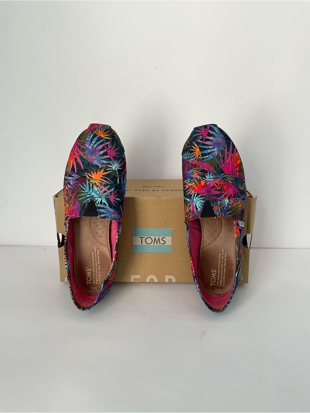 Toms Women's Black Slip-On Flats with Multicolor Palm Floral Accents
